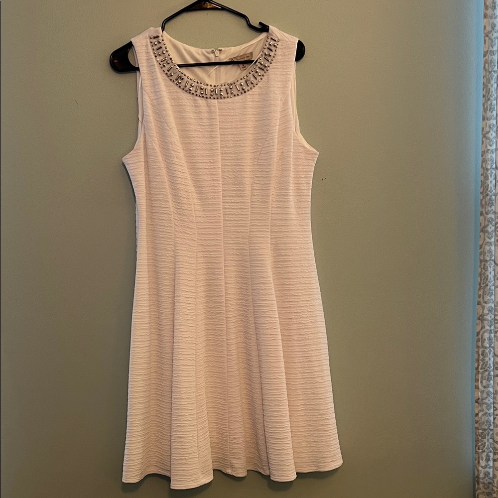 Elegant White Sleeveless Dress with Embellished Neckline